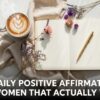 A cozy setting with an open journal, a gold pen, and colorful flowers on a white surface. A latte with heart foam is nearby. Text reads, "100 Daily Positive Affirmations for Women That Actually Work.”